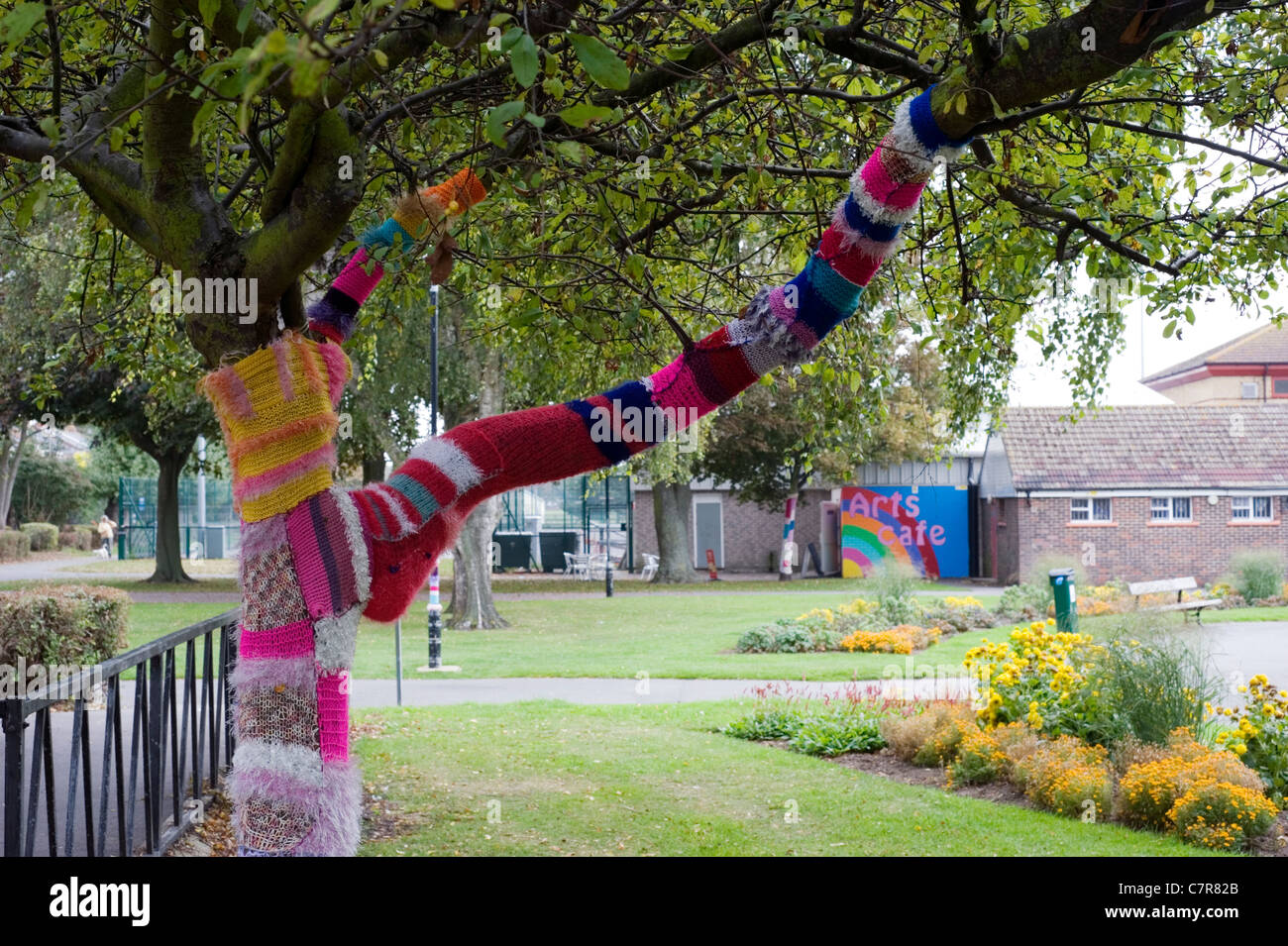 tree that has been yarn bombed in a park in southsea Stock Photo
