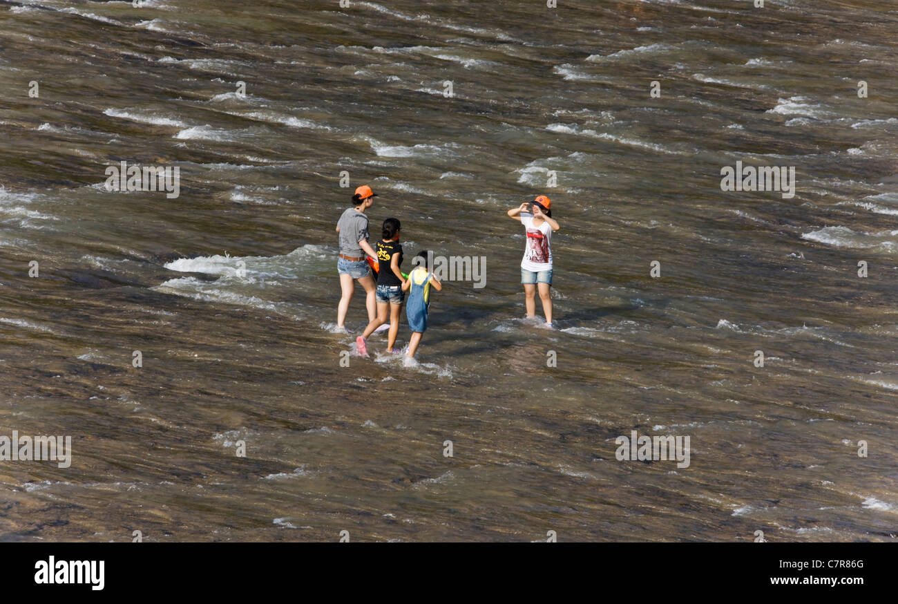 People playing in shallow water at Pingnan White Water Square (Baishuiyang), Pingnan, Fujian Province, China Stock Photo