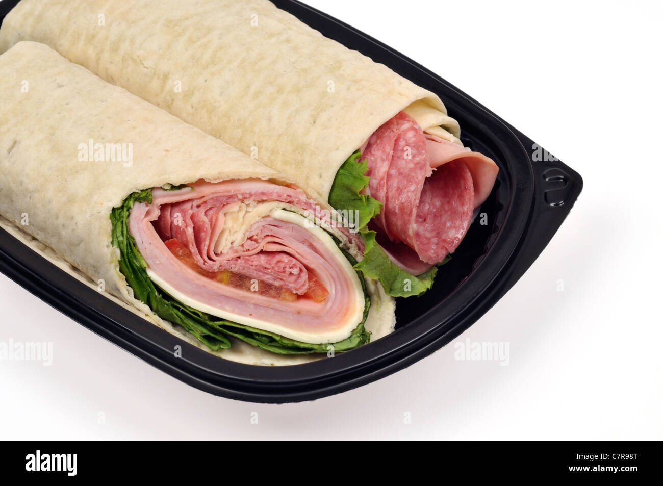 Italian sandwich  wrap cut in half on black plate on white background.  USA. Stock Photo