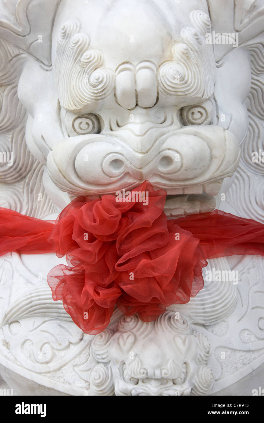 Lion statue with a bow, Shanghai, China Stock Photo