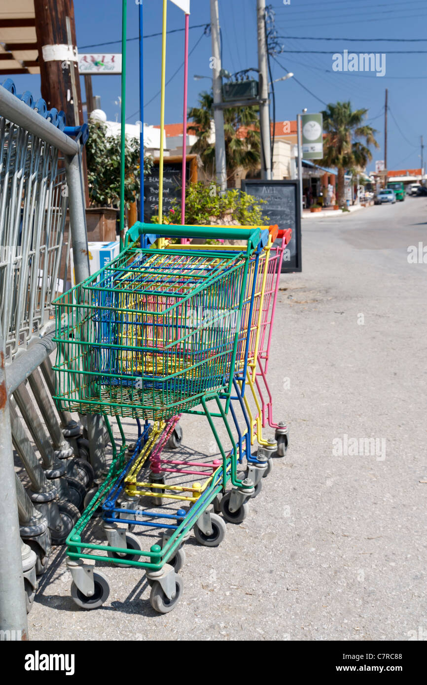 Small colored shopping carts in a street in Almirida, a small Village on Crete, Greece. Stock Photo