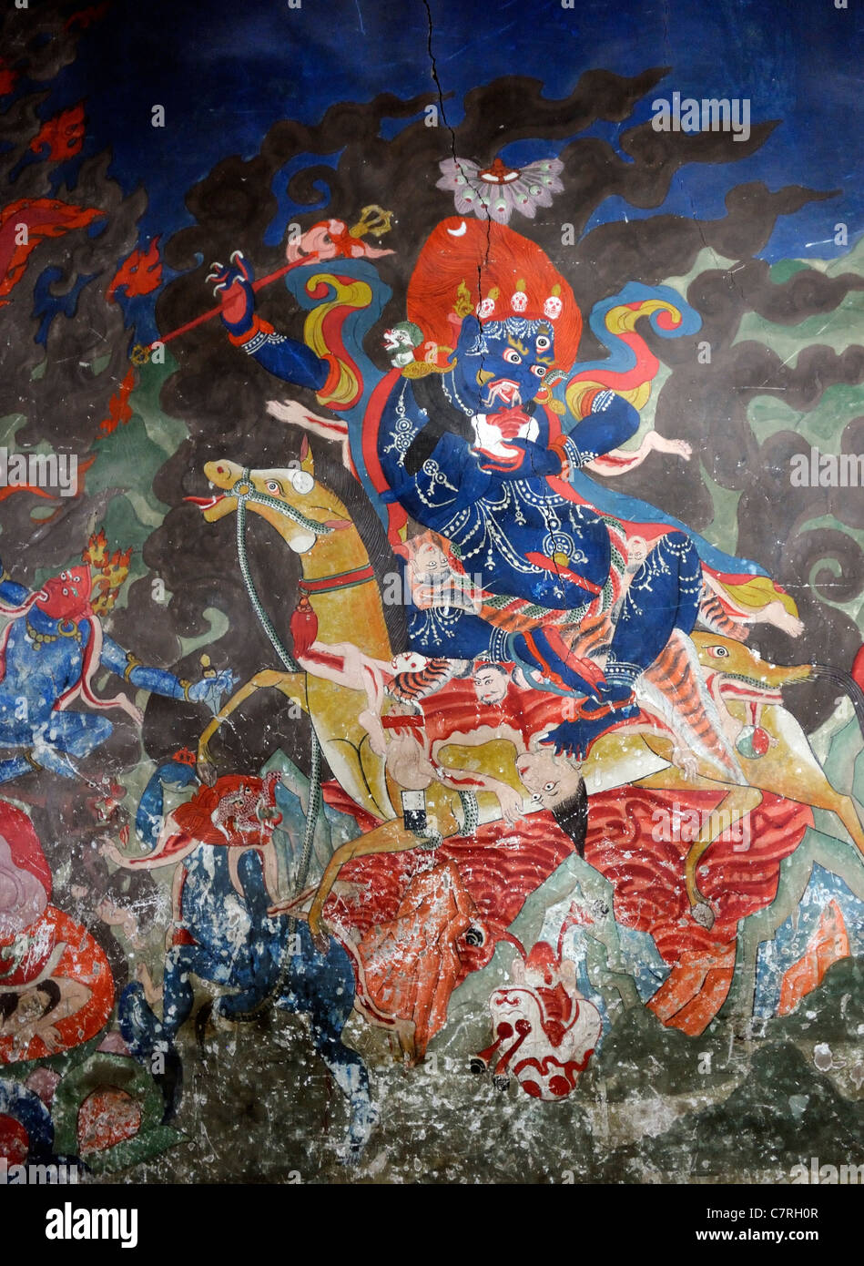 A wall painting of Shri Devi, Palden Lhamo, the Glorious Goddess with her red hair, riding on her three eyed white mule. Stock Photo