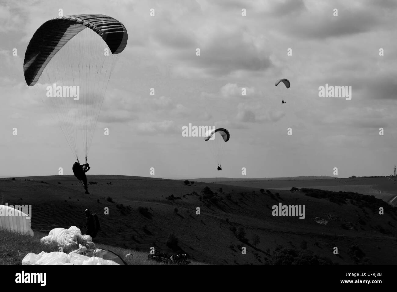 Parascending off of Devils Dyke in black and white Stock Photo
