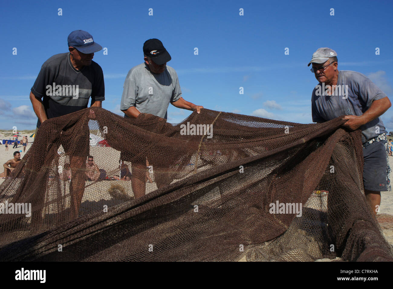 Old fishermen mending their nets hires stock photography and images