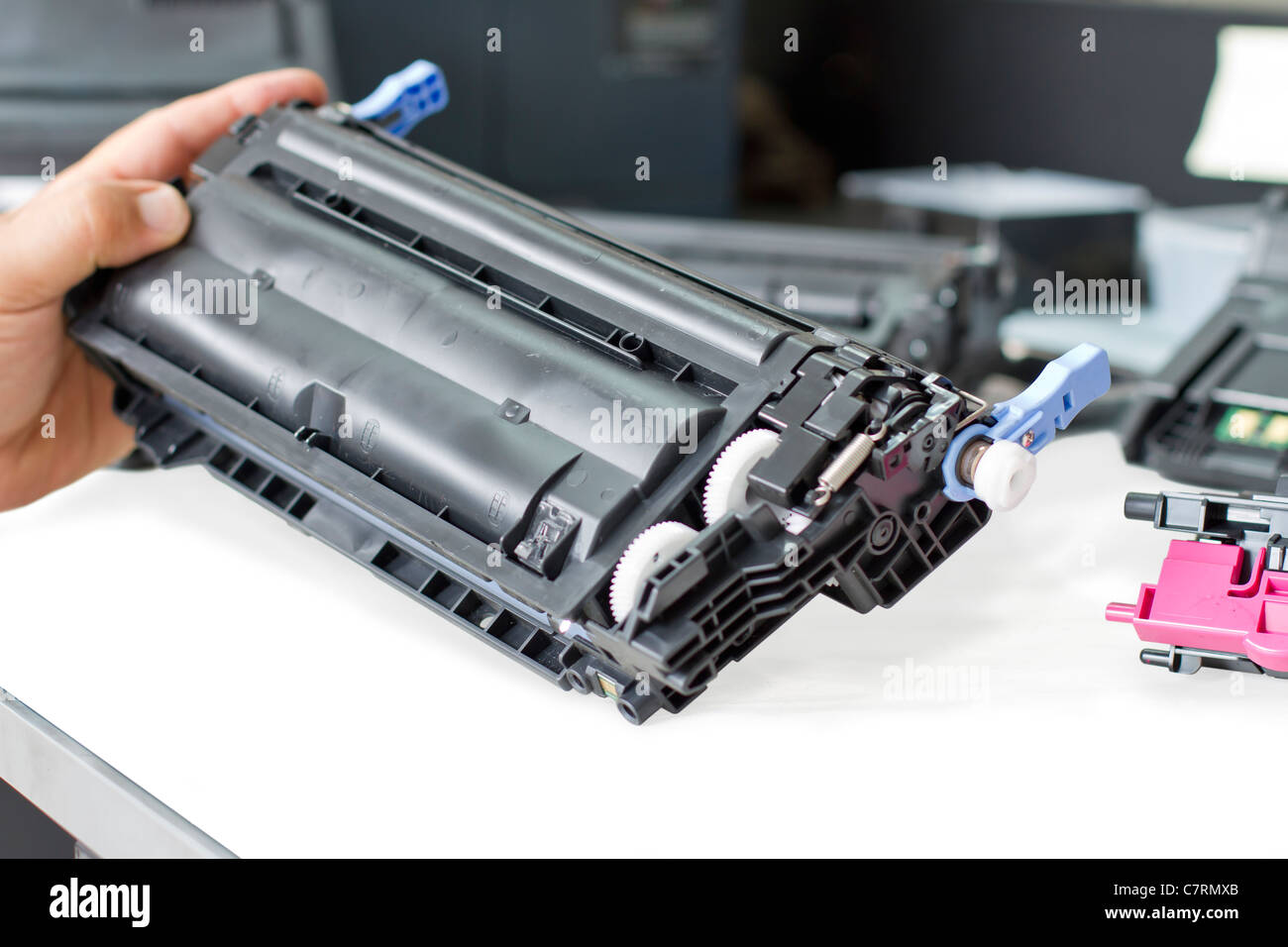 Exploding Toner hands repairing laser toner cartridge Stock Photo - Alamy