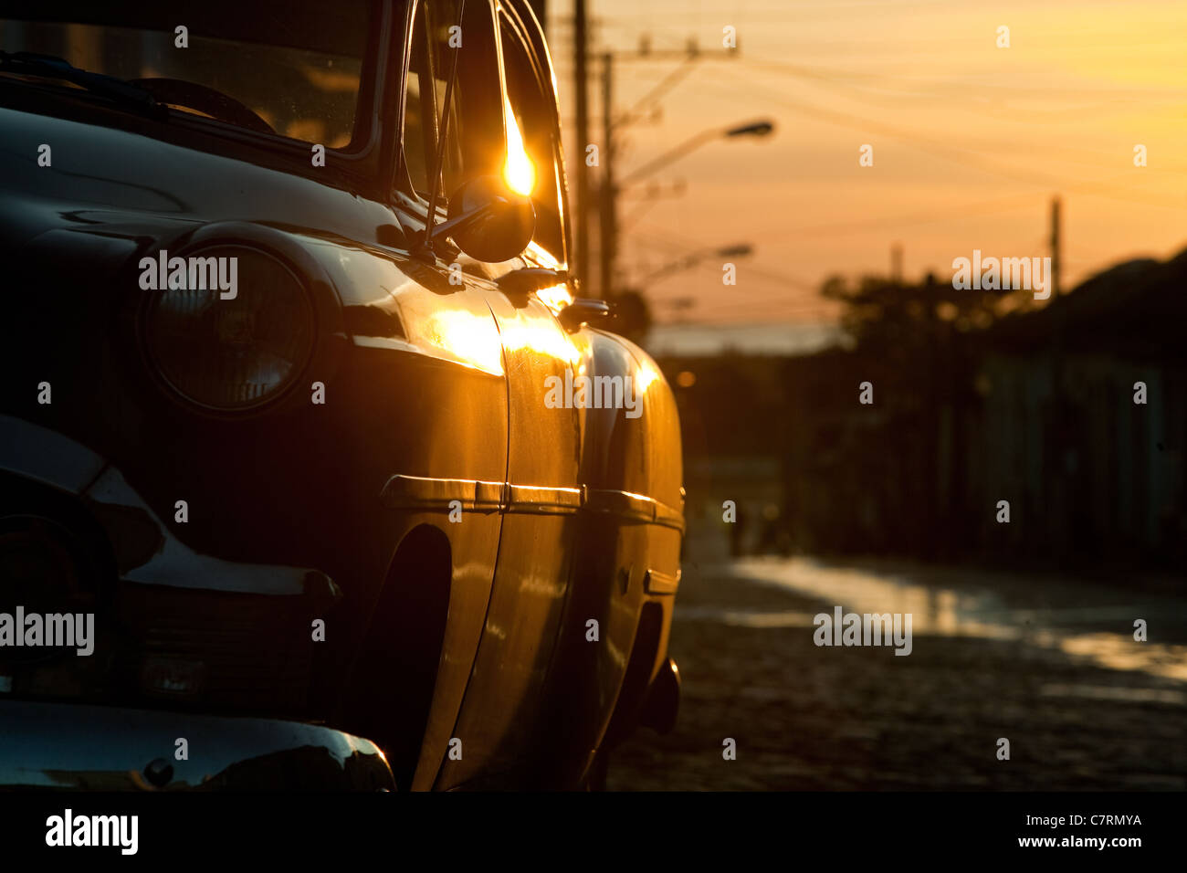 Vintage car on cobblestone street at sunset Cuba Trinidad Stock Photo ...