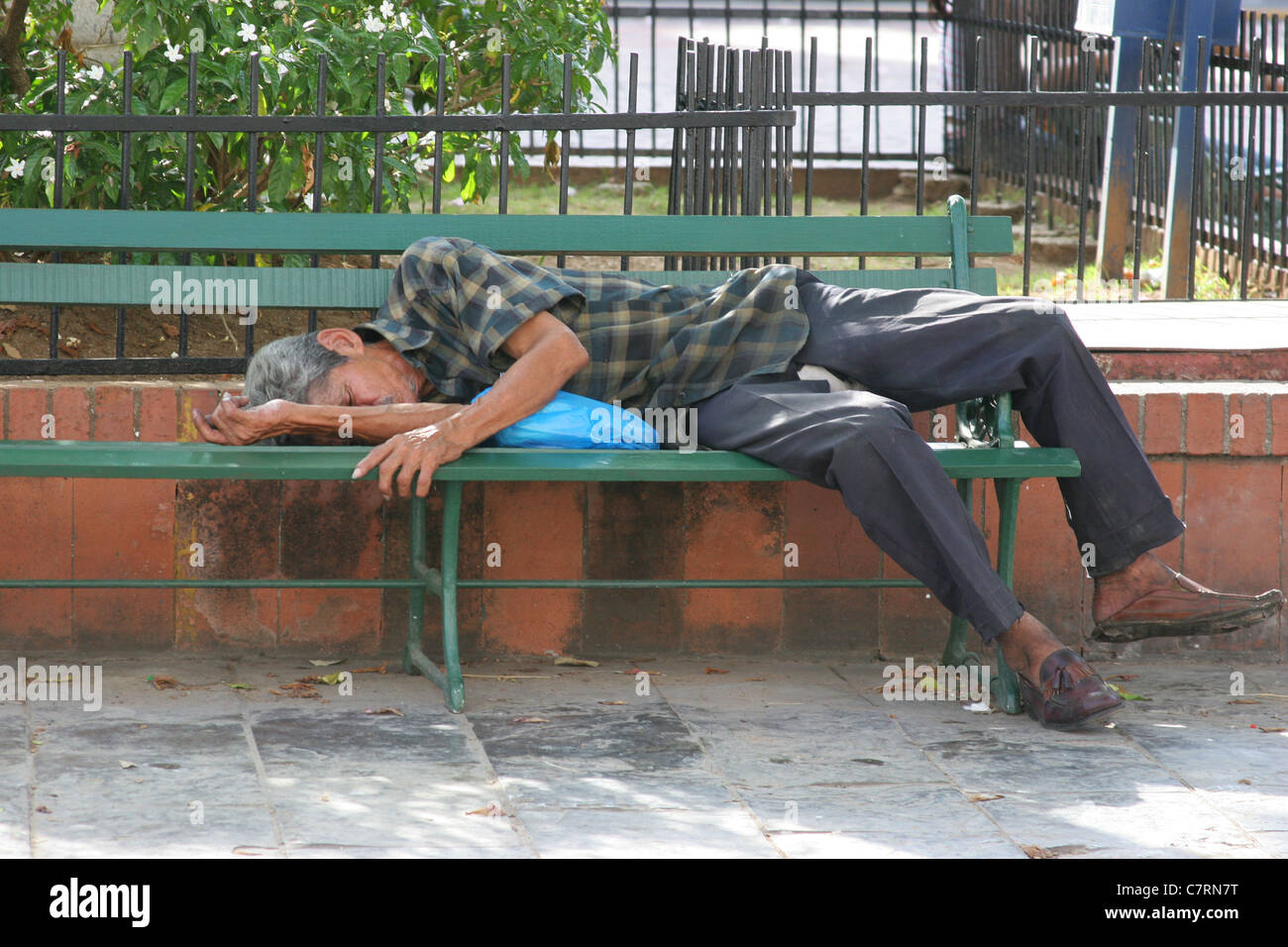 Homeless Man Sleeping In A Park Bench Stock Photo Alamy
