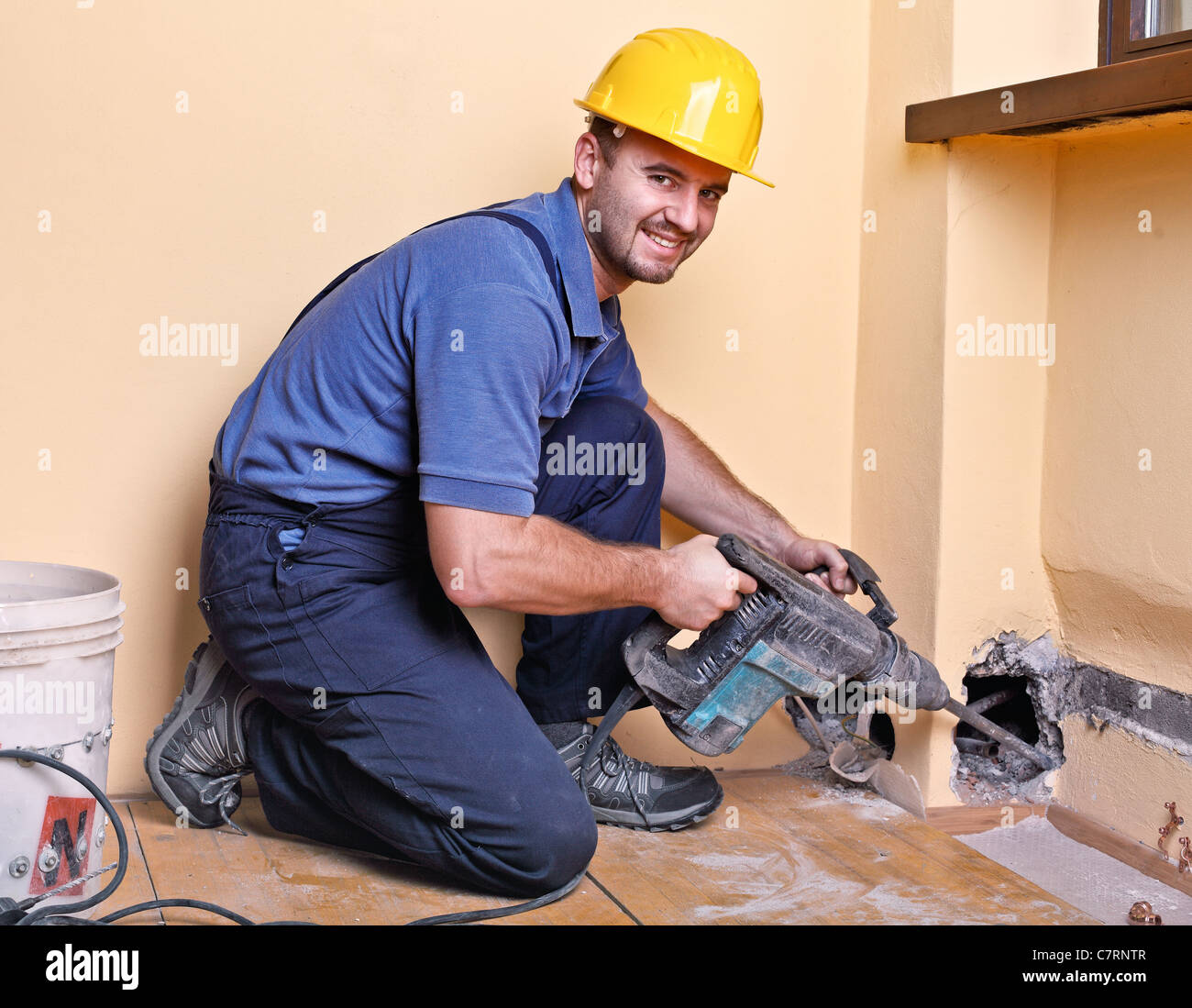 caucasian handyman with big drill on duty Stock Photo