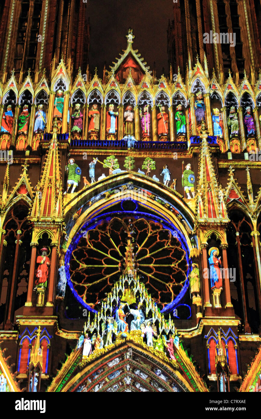 Reims cathedral at night illuminated by projected coloured lights. Champagne-Ardenne region of France Stock Photo