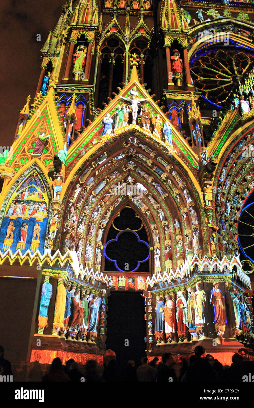 Reims cathedral at night illuminated by projected coloured lights. Champagne-Ardenne region of France Stock Photo