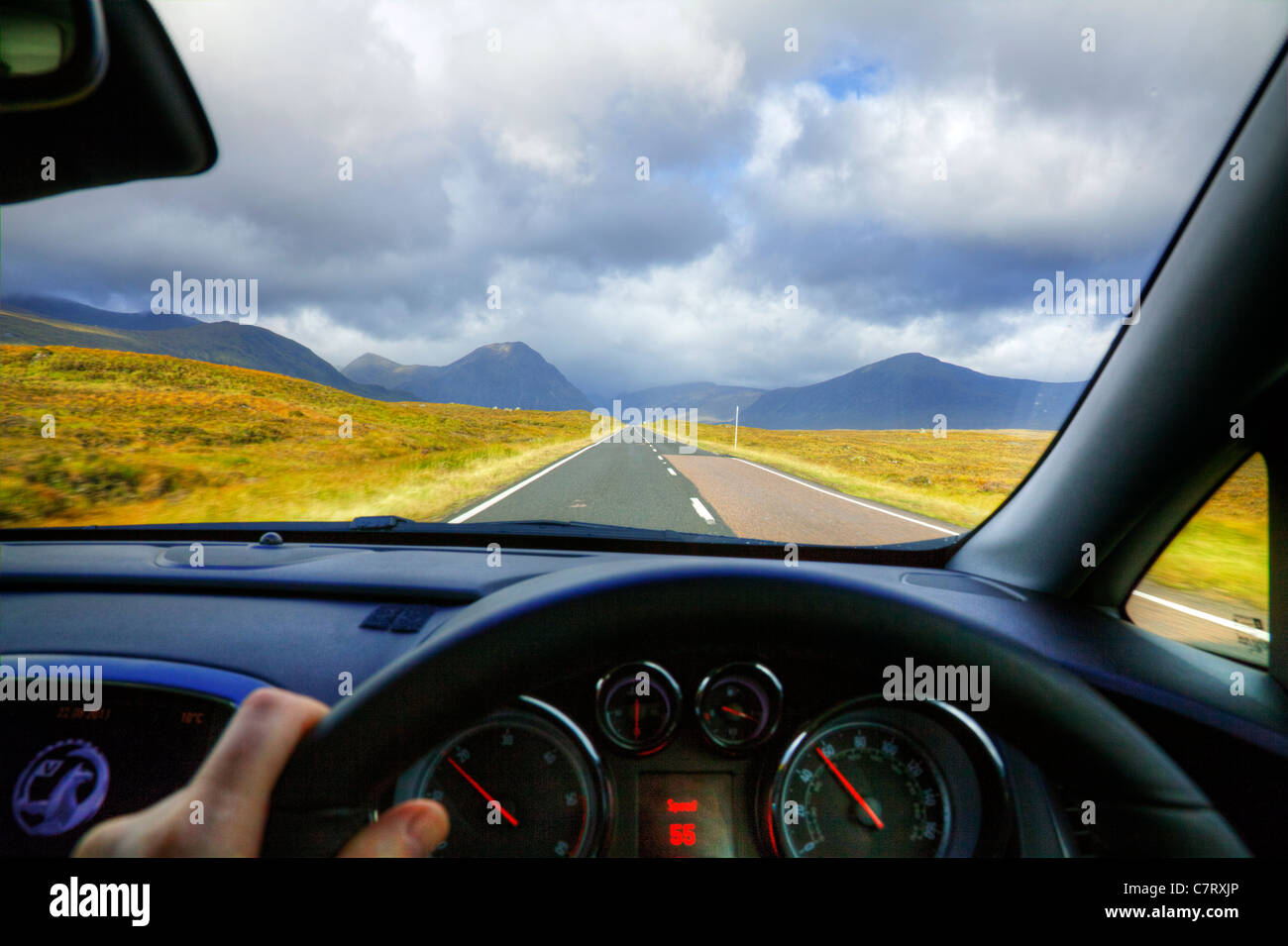 Driving along in a new Vauxhall Astra towards the Scottish Highlands doing 55 miles per hour on speedometer Stock Photo
