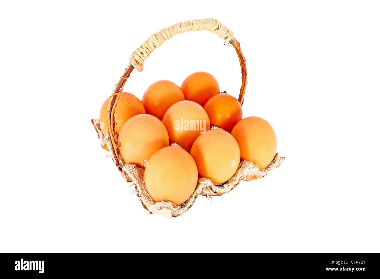 Chicken eggs in a basket made of natural materials, isolated Stock Photo