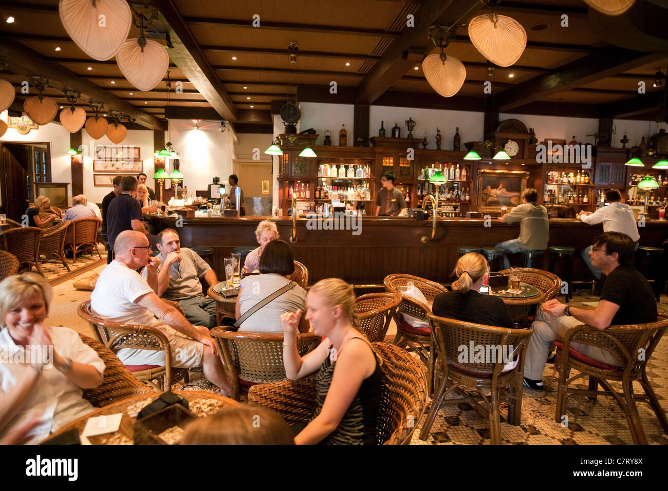 Raffles Long Bar; People drinking in the Long Bar, home of the Singapore Sling; Raffles Hotel, Singapore Asia Stock Photo