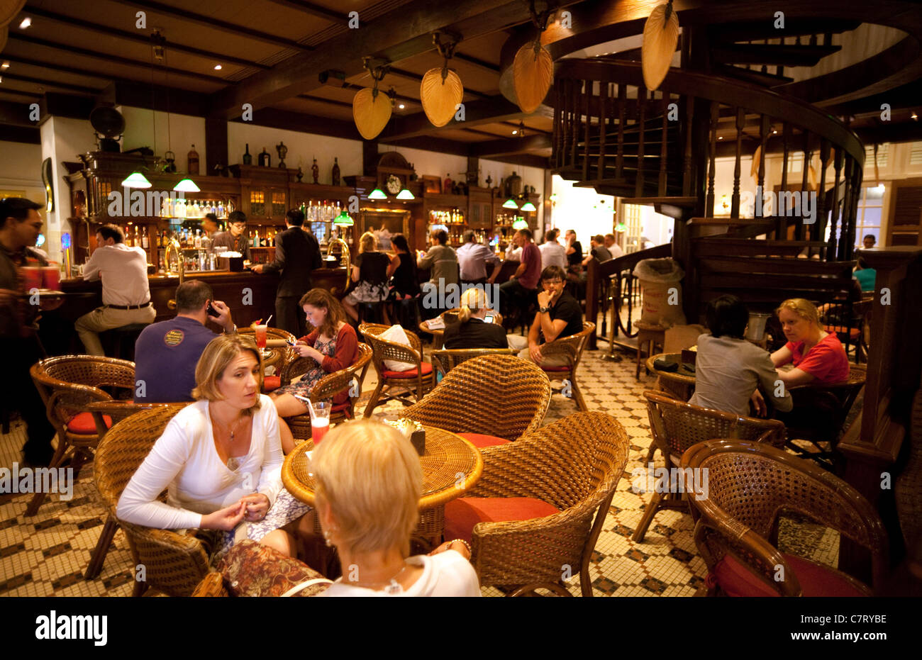 People drinking in the Long Bar, Raffles Hotel, Singapore asia Stock Photo