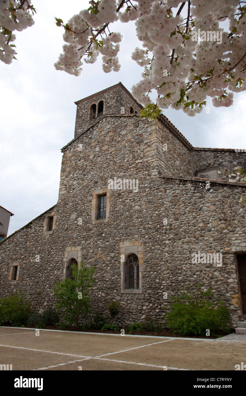A church with blossom tree in Quillan, near Limoux S Aude, France Stock Photo