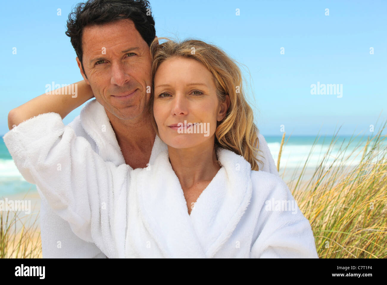 couple in robes on the beach Stock Photo - Alamy