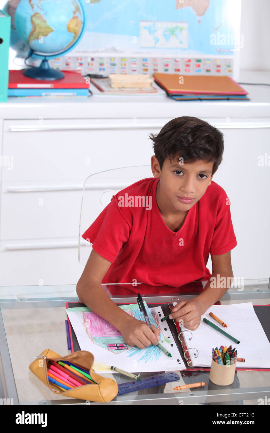Schoolboy drawing in class Stock Photo - Alamy
