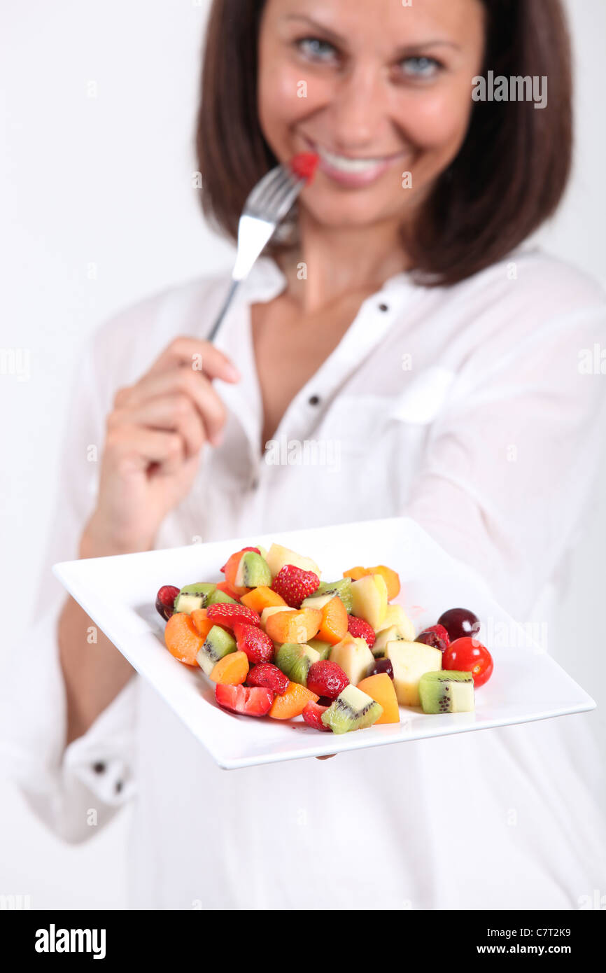 Woman eating fruit salad Stock Photo Alamy