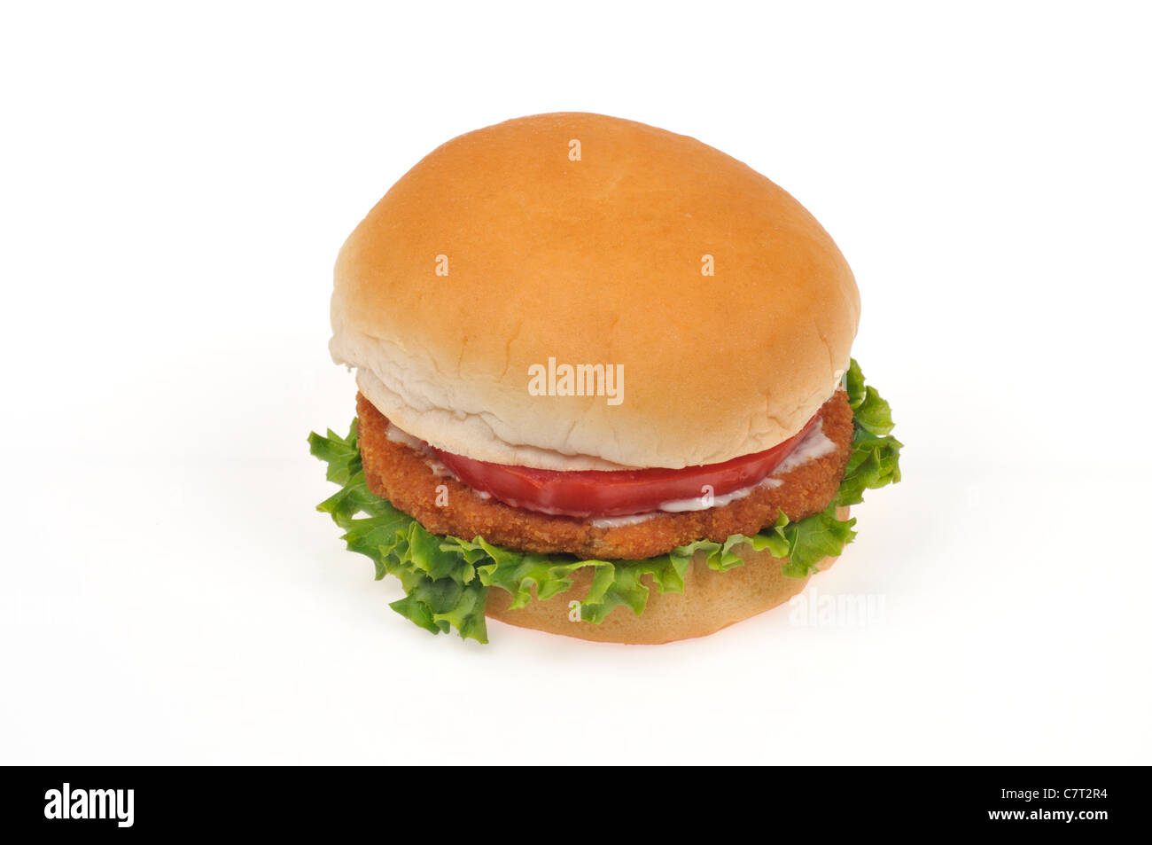 Chicken burger with mayo, lettuce and tomato on a bread roll on white background cutout. Stock Photo