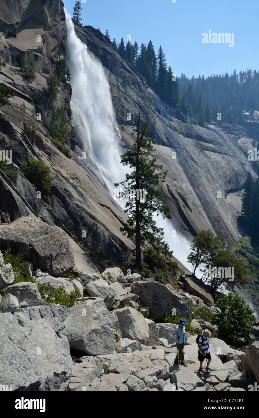 Hikers on the trail with Nevada Fall in background. Yosemite National Park, California, USA. Stock Photo