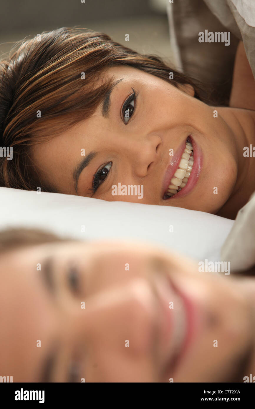 Couple smiling in bed Stock Photo