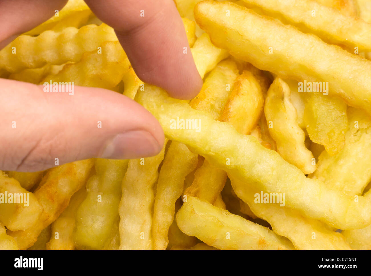 Grabbing a french fry Stock Photo Alamy