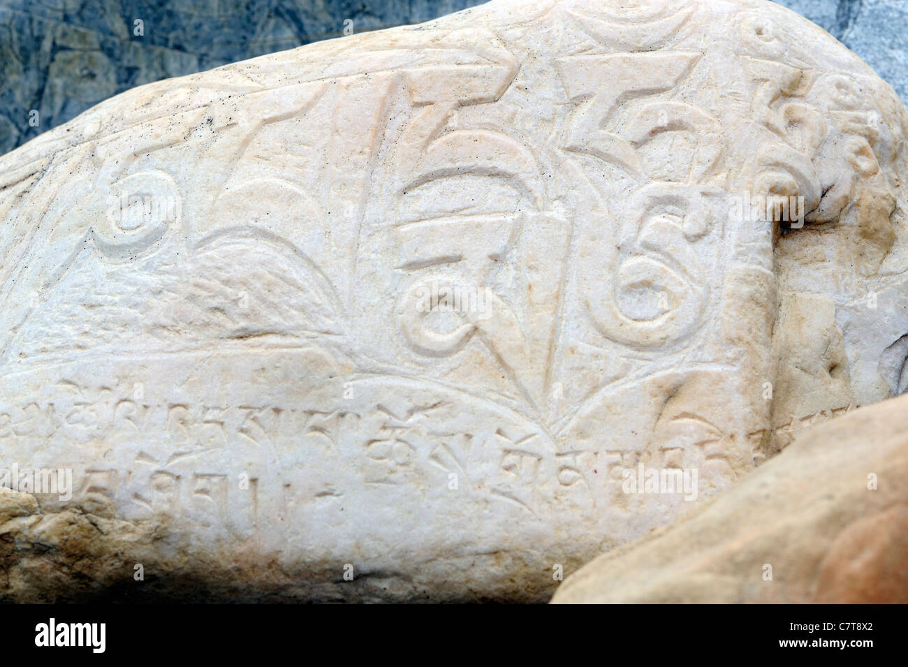 A river boulder carved with the mantra om mani padme hum on a prayer wall.  Sumar, Nubra Valley, Ladakh, Republic of India. Stock Photo