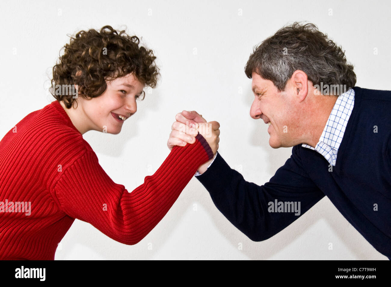Father and son arm wrestling Stock Photo