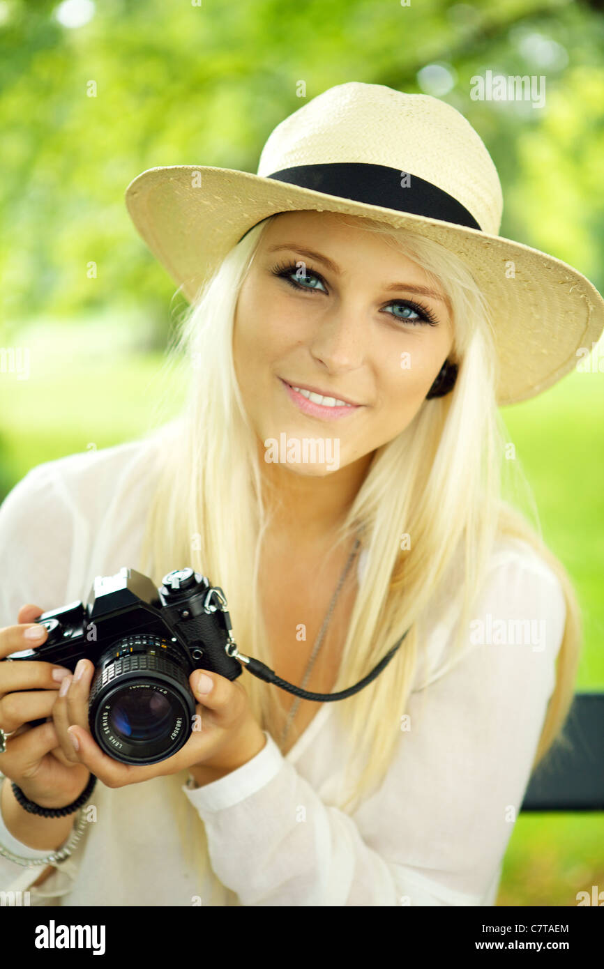 Portrait of a beautiful smiling female with a camera Stock Photo - Alamy