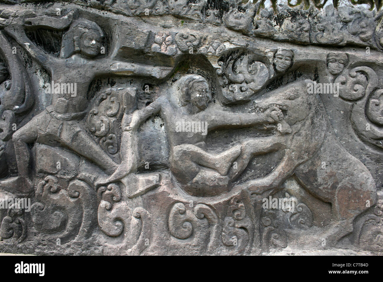 Rock Art Relief Showing Men Hunting Wild Boar at Yeh Pulu, Bali Stock Photo