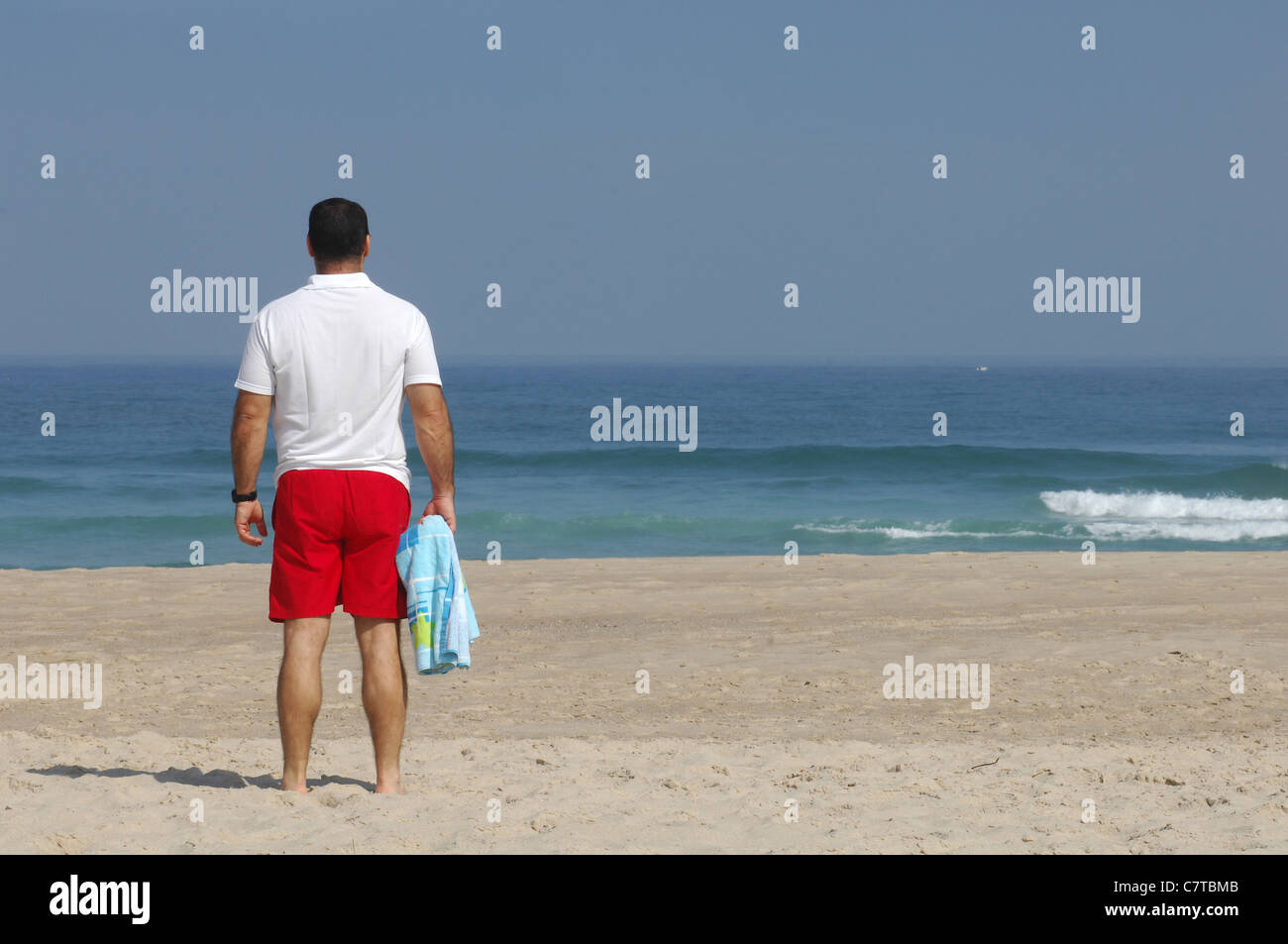 Men Looking to the sea on the beach Stock Photo - Alamy