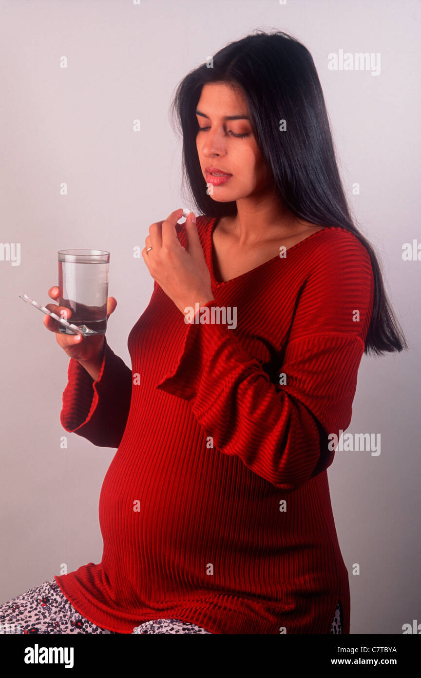pregnant woman taking a pill Stock Photo Alamy