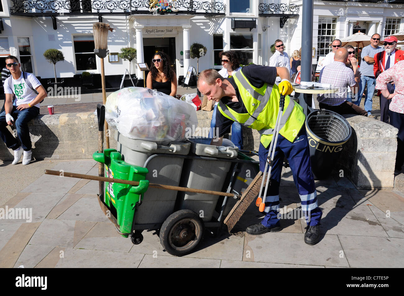 Council worker street cleaner emptying public waste bins. Stock Photo