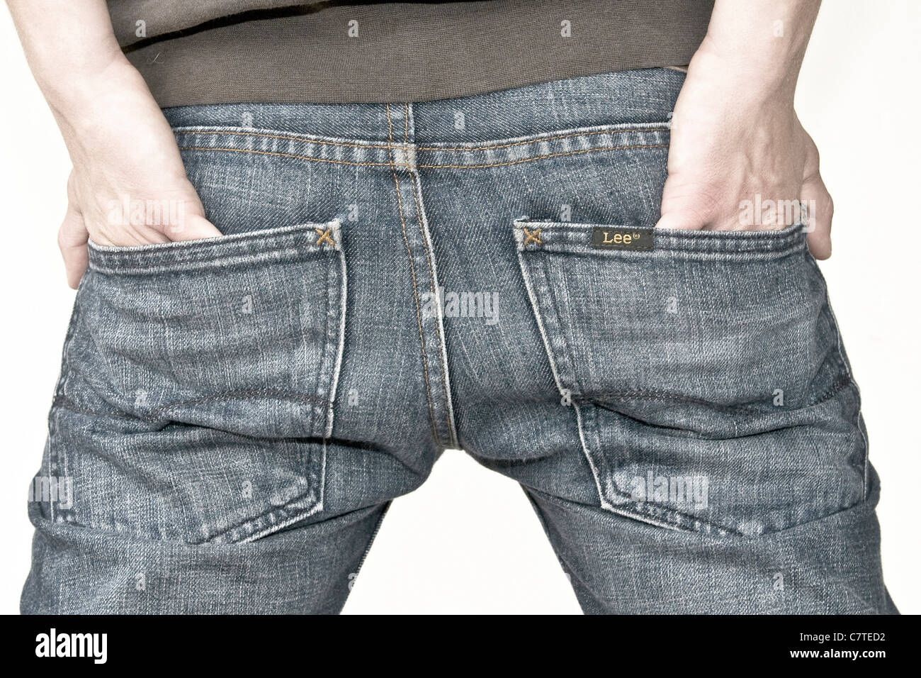 rear view of young man putting hands in pockets of his jeans Stock Photo