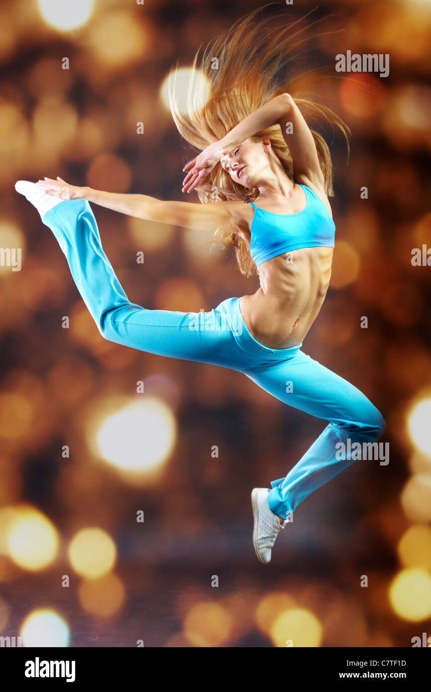 Young girl making acrobatic leap Stock Photo