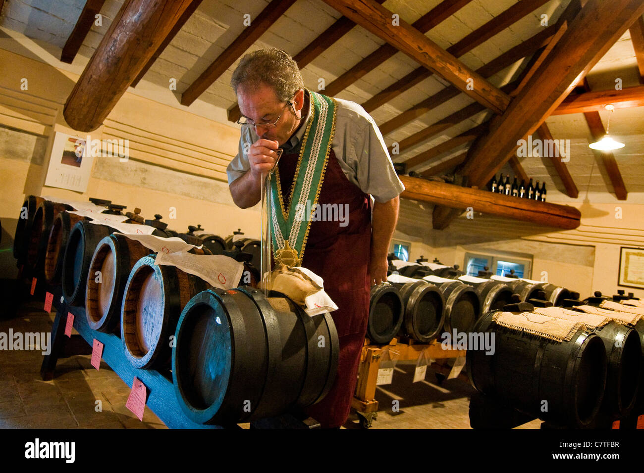 Italy, Emilia Romagna, Modena, expert Roberto Chierici tasting balsamic vinegar from barrels Stock Photo