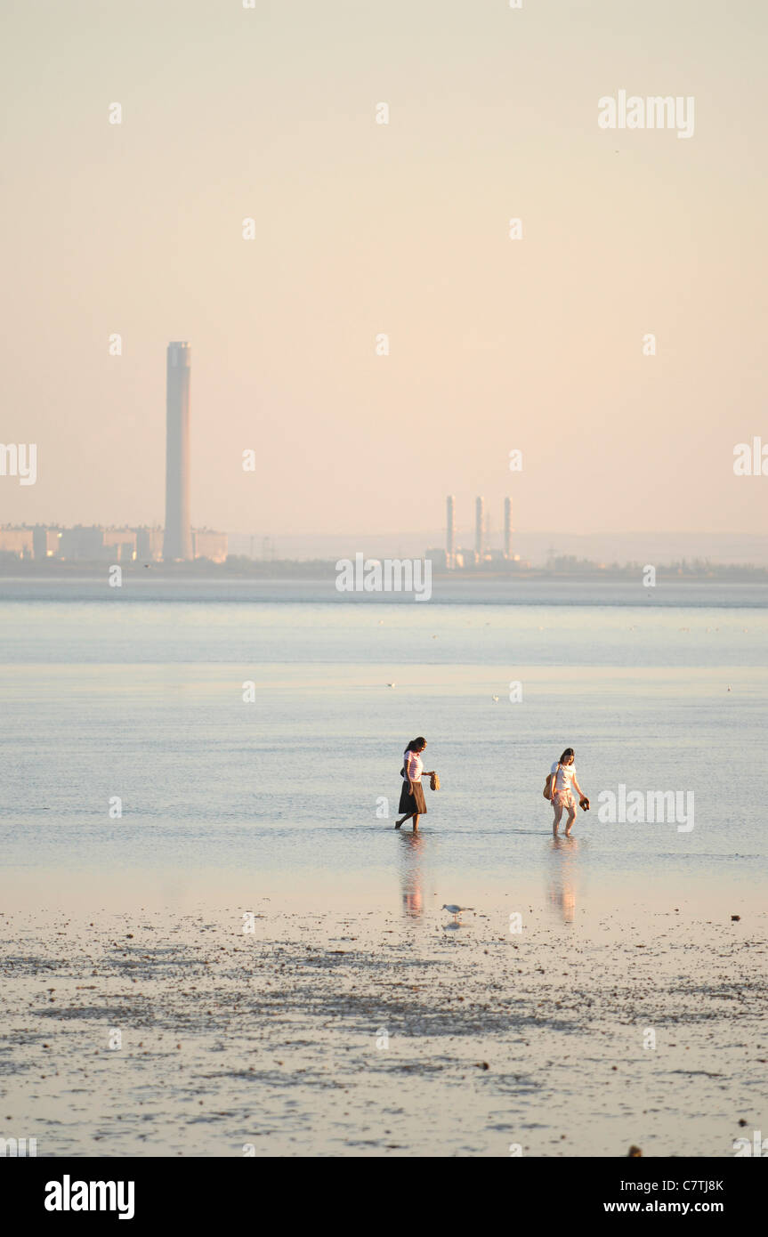 Two young women paddle in the sea at Southend, Essex, England, UK. Europe. Photo Graham M. Lawrence. Stock Photo