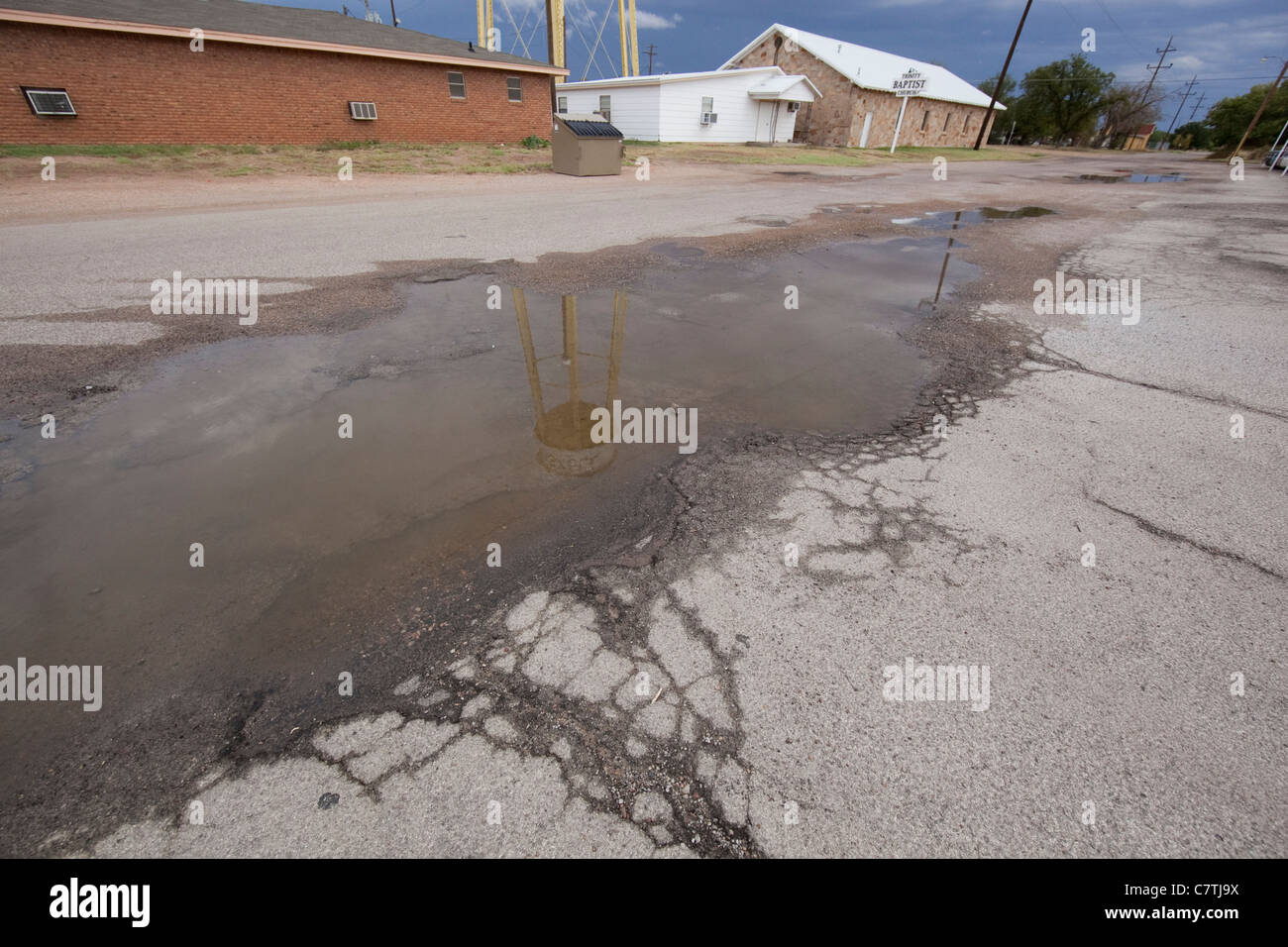 Reflection of water tower in puddle in downtown Haskell, Texas, hometown of Texas first lady Anita Thigpen Perry. Stock Photo
