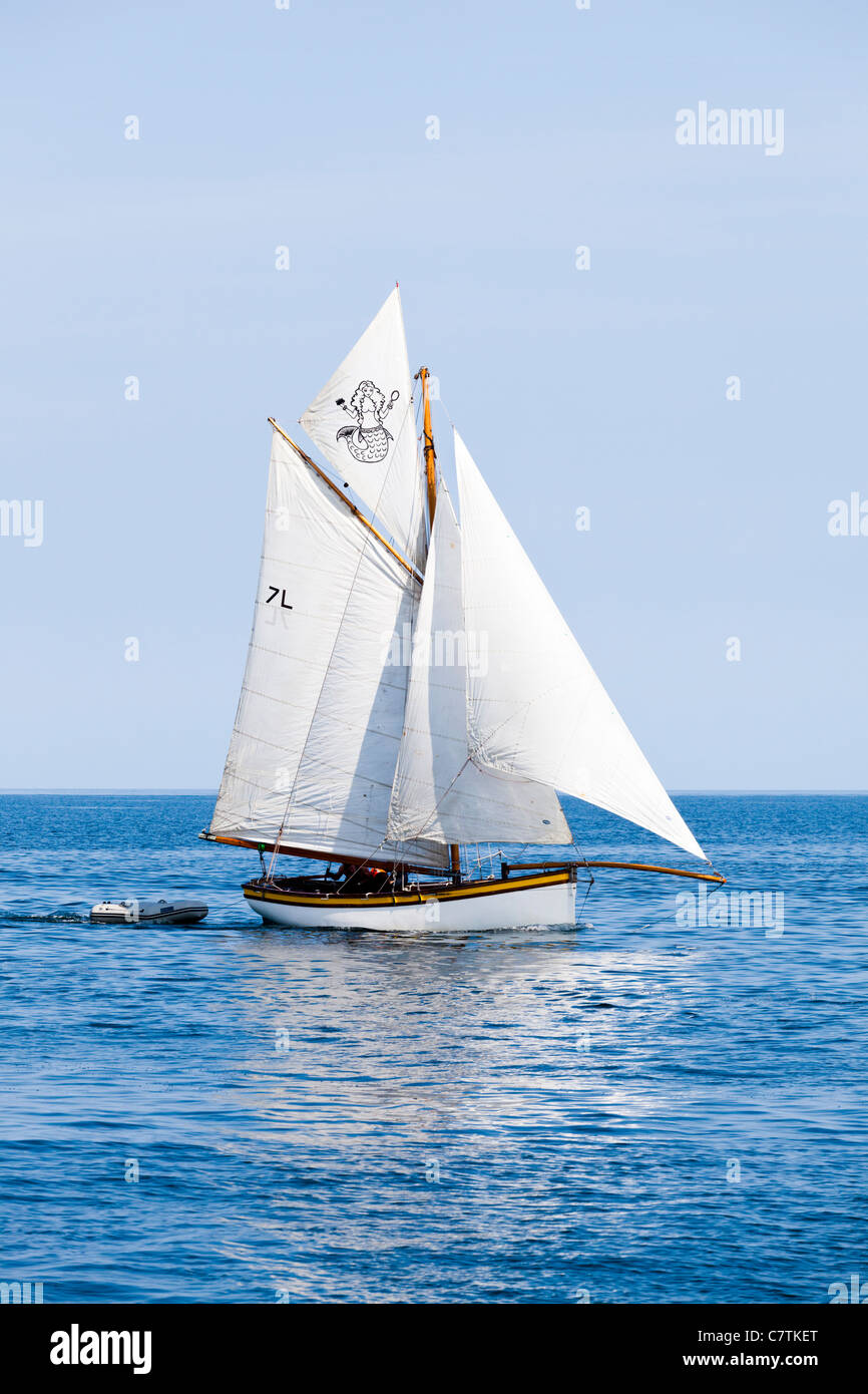 A Falmouth oyster boat in the calm waters of Falmouth Bay, Cornwall UK Stock Photo