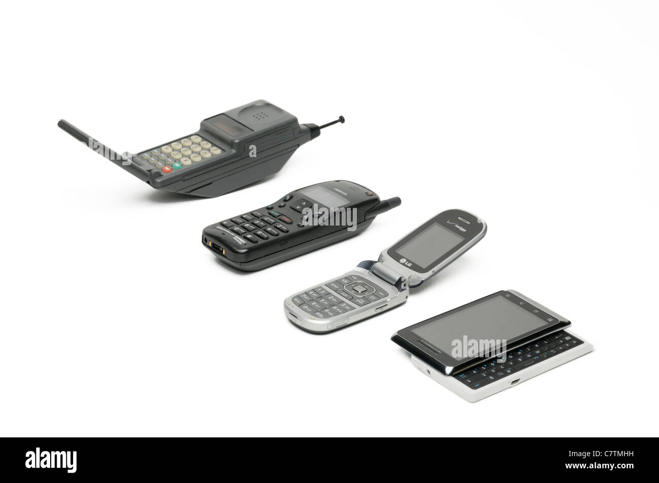 Mobile/cell phone evolution.  Four generations of phones getting progressively smaller and more functional Stock Photo