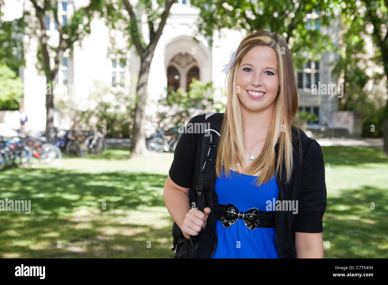Portrait of a cute teenage girl holding backpack Stock Photo - Alamy