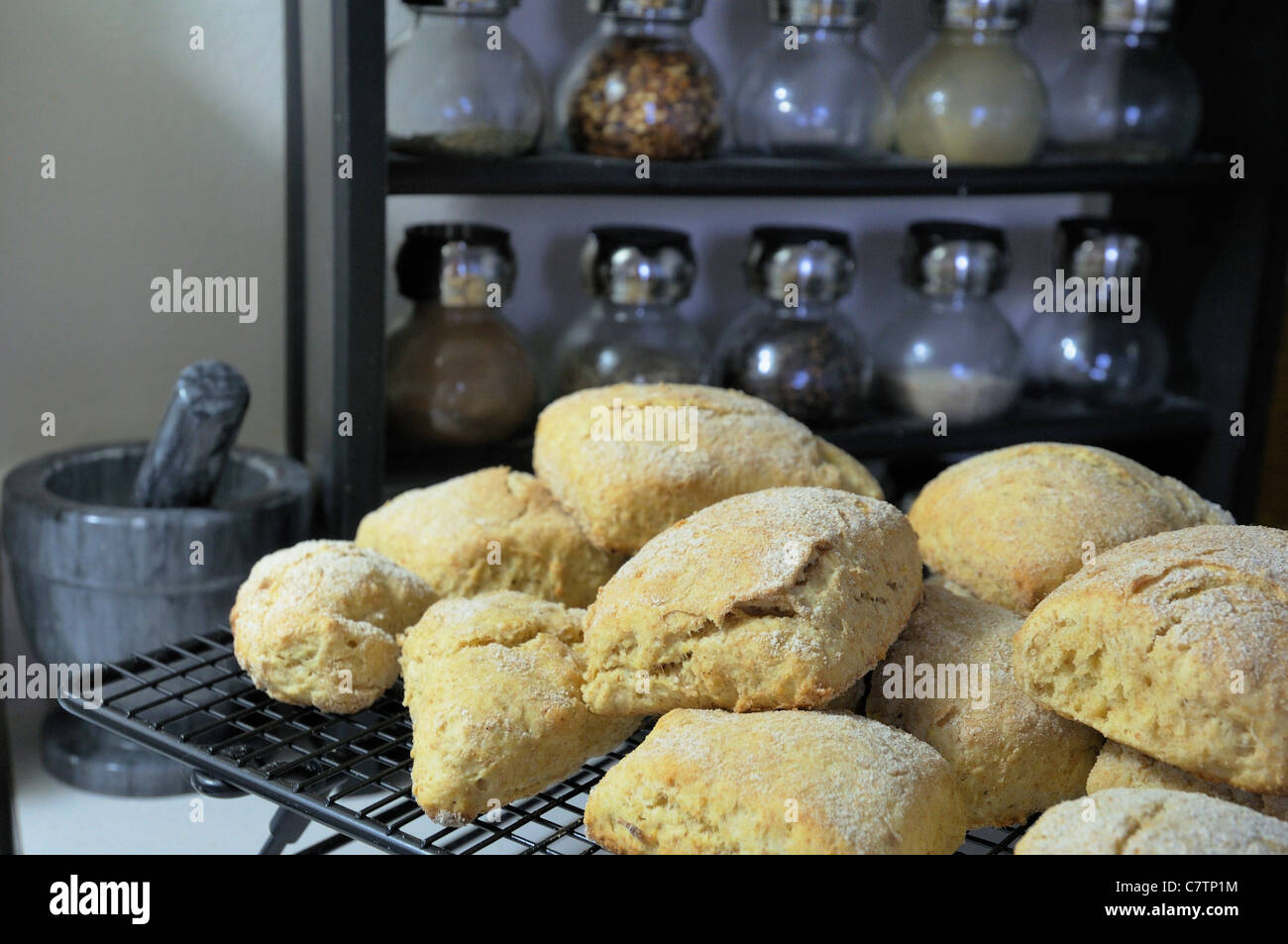 A dozen tea biscuits sit cooling. Stock Photo