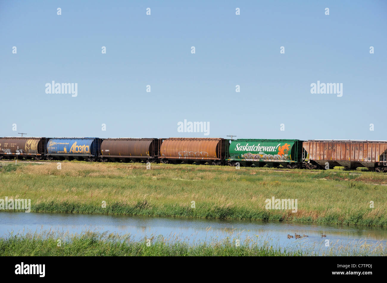 Landscape of the Canadian prairies of North America with a train, Saskatchewan Canada. Stock Photo