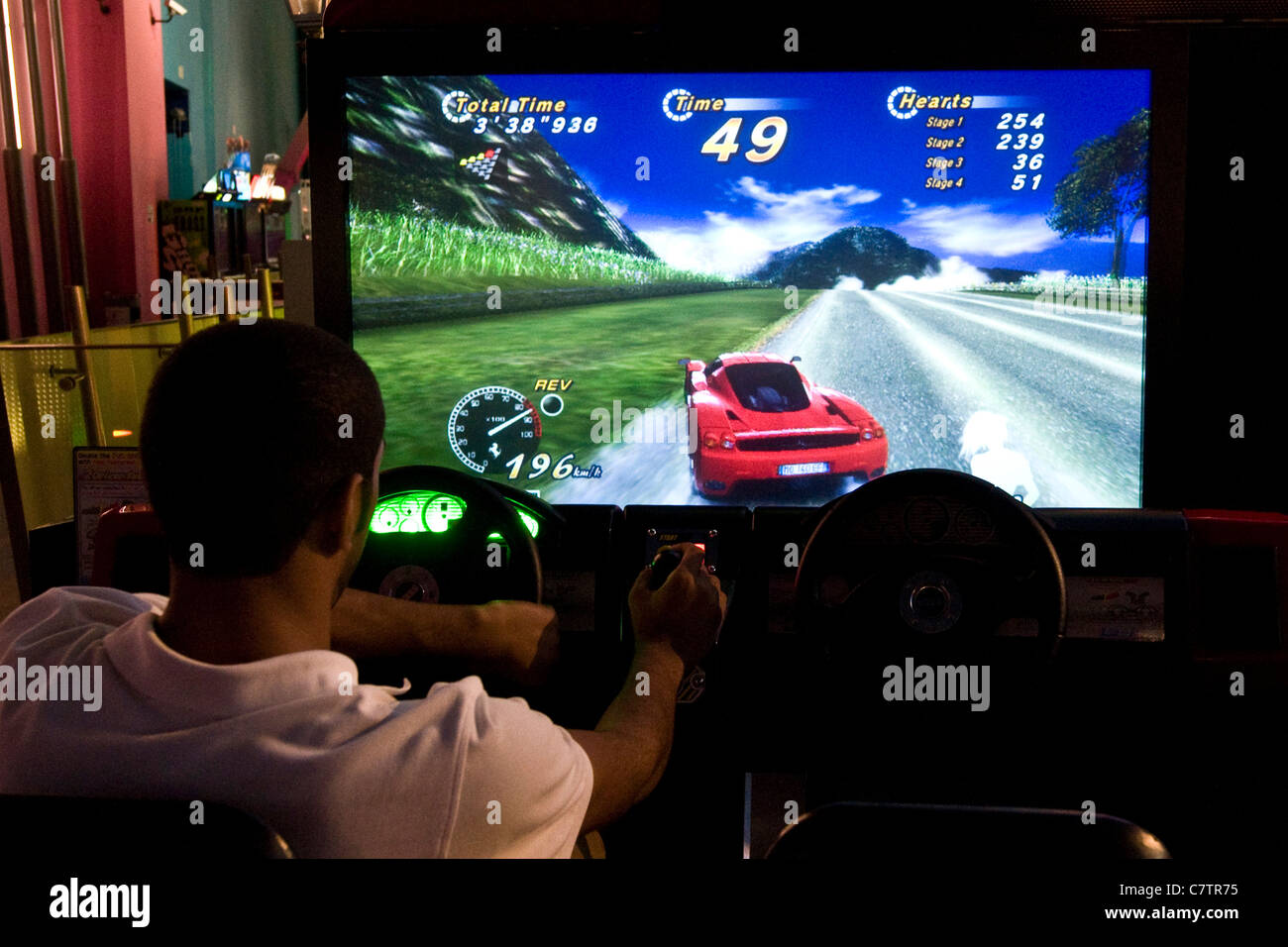 Man playing with videogame in arcade Stock Photo
