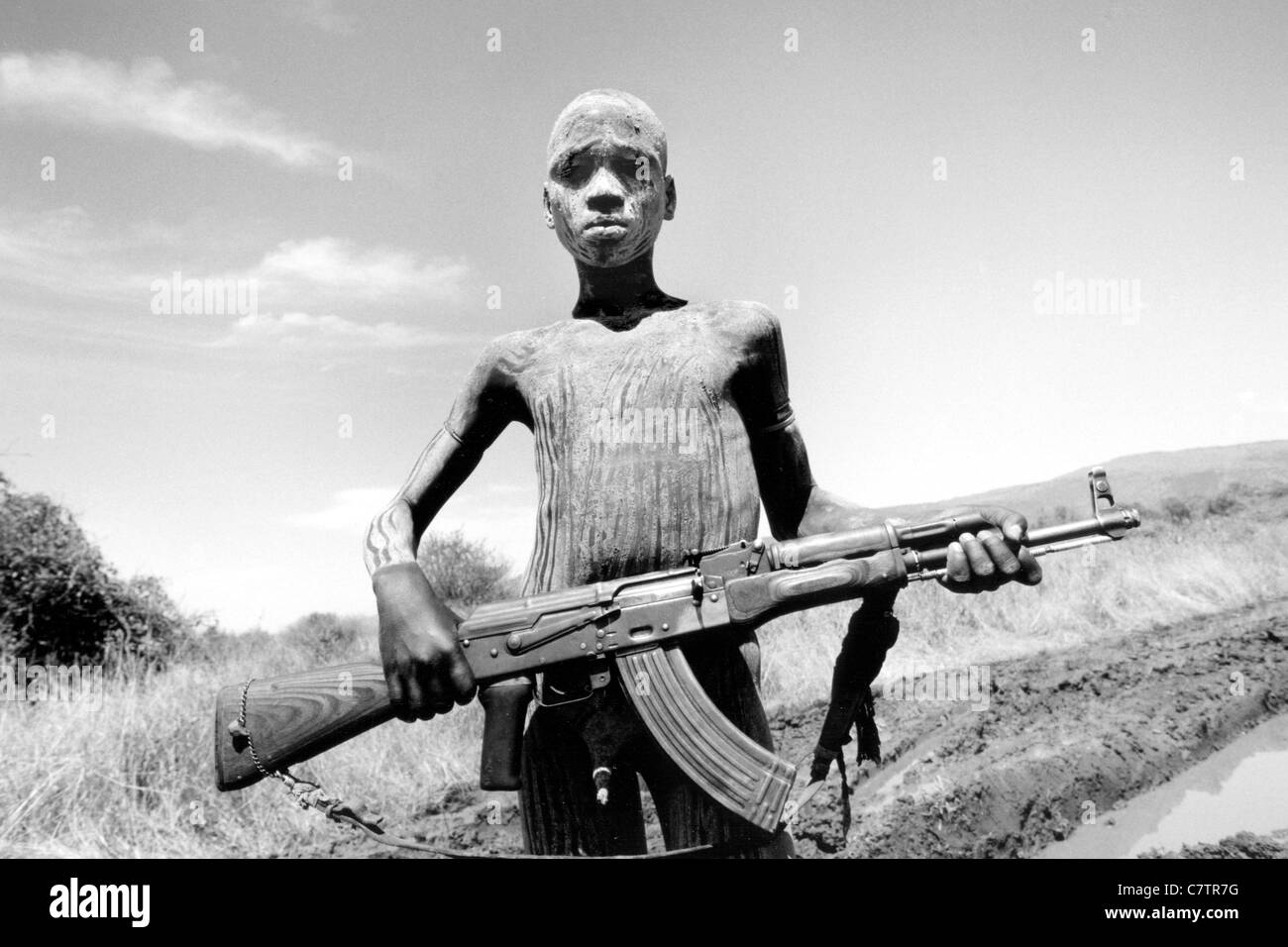 Africa, Ethiopia, South Omo, Mago National Park, Mursi man with body painting and AK47 rifle Stock Photo