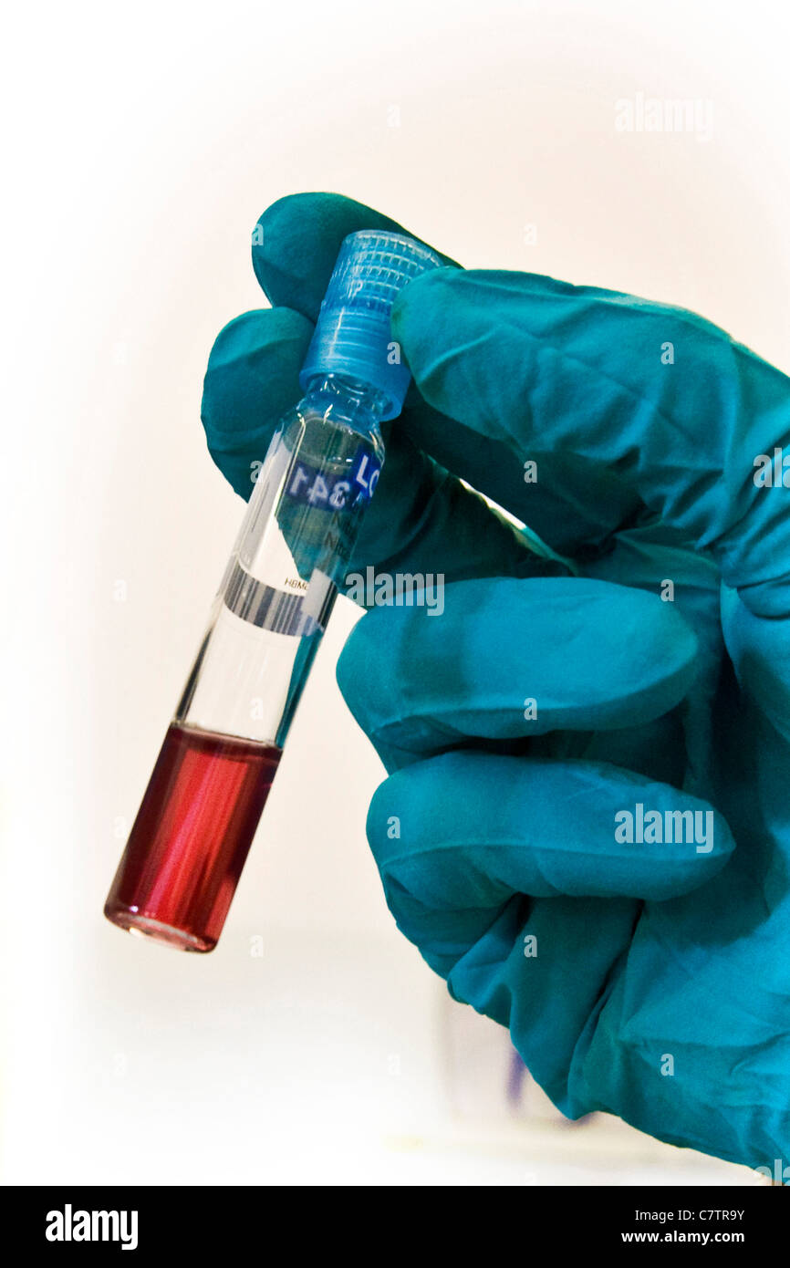 Close up of hand of scientist with test tube Stock Photo