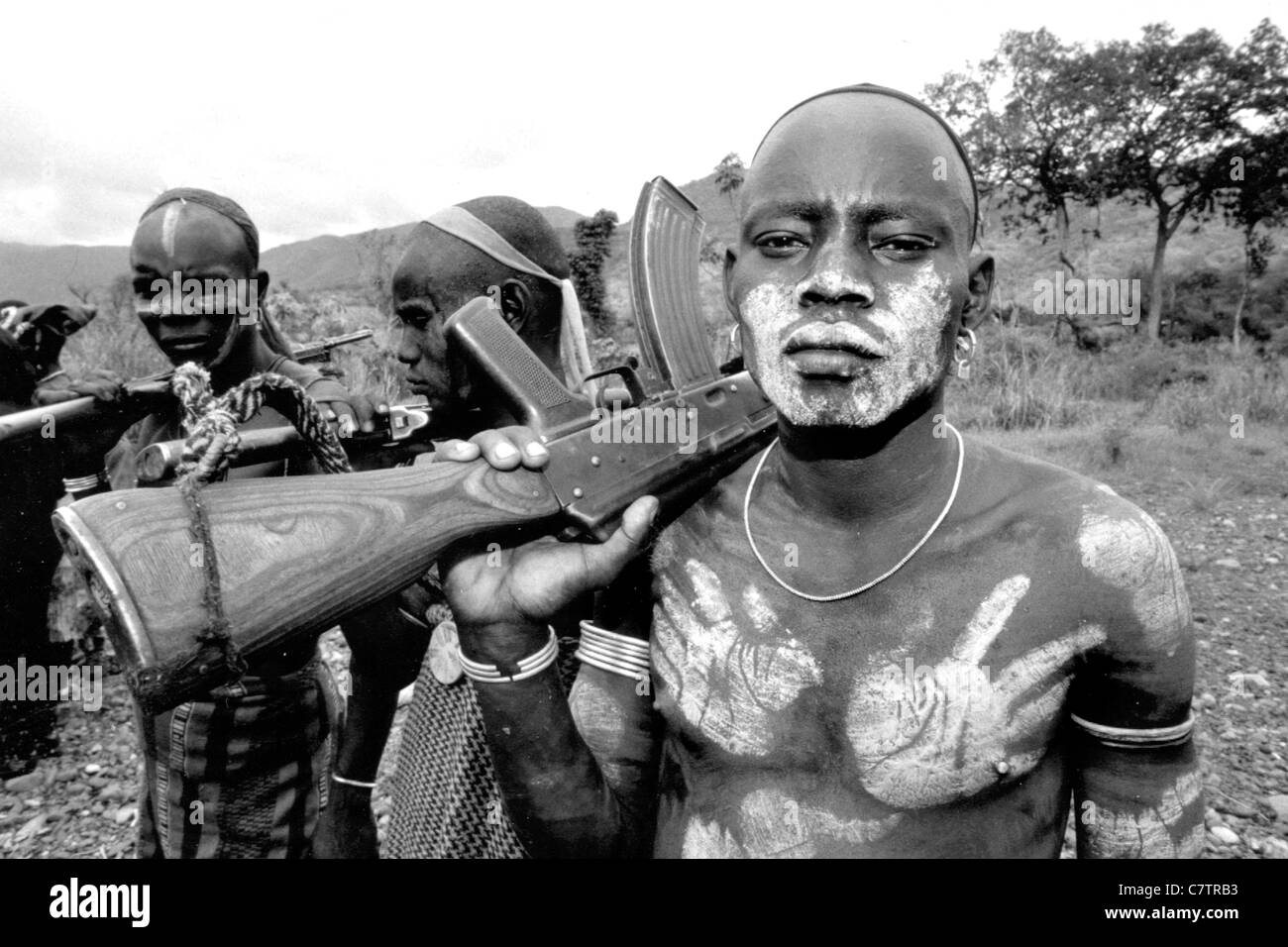 Africa, Ethiopia, South Omo, Mago National Park, Mursi man with body painting and AK47 rifle Stock Photo