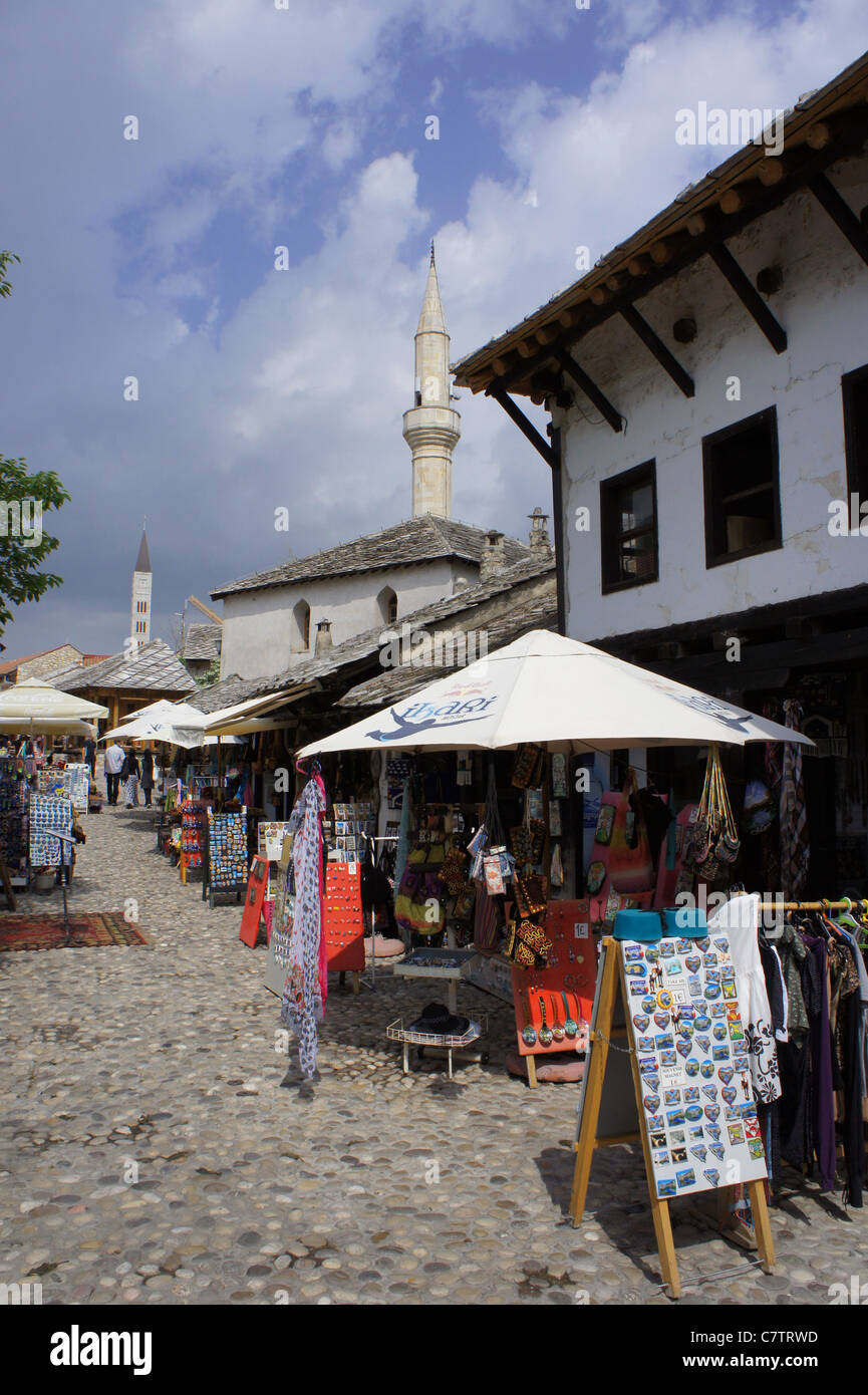 Market booths at Bazar in Mostar,Minaret and church tower Bosnia Herzegovina Stock Photo