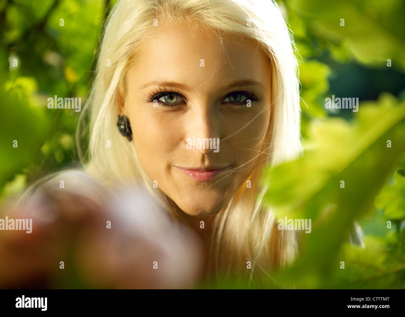 Close-up portrait of a cute smiling female in a forest Stock Photo - Alamy