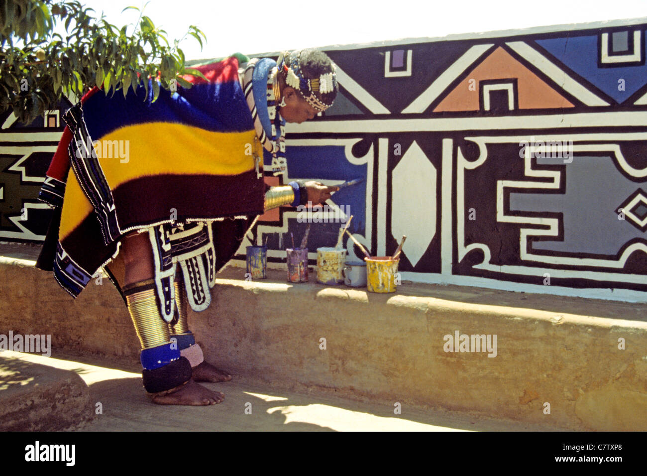 South Africa, Ndebele, woman painting the wall of her home Stock Photo